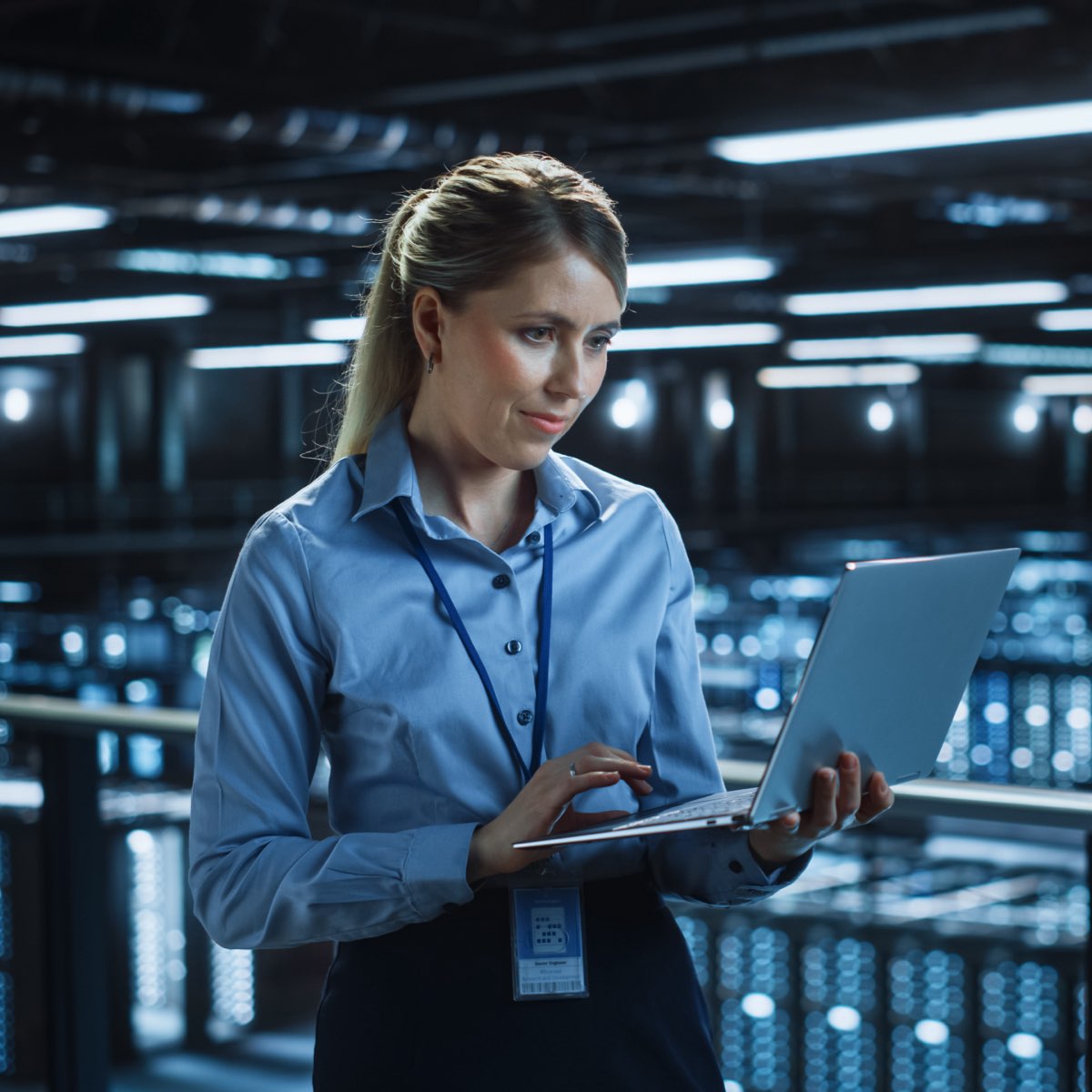 Woman on laptop in operations room