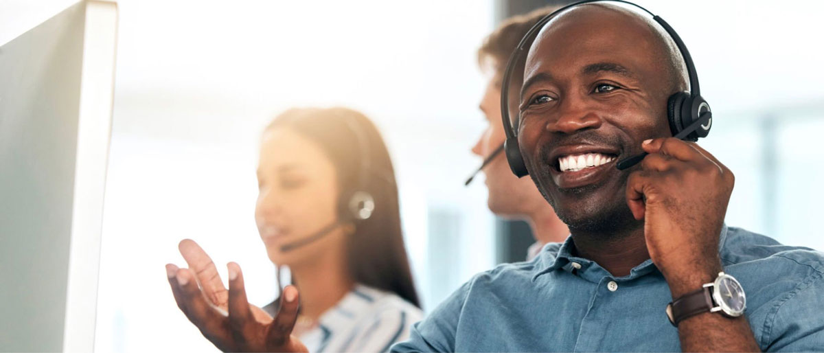 A man assisting someone through a headset over the phone