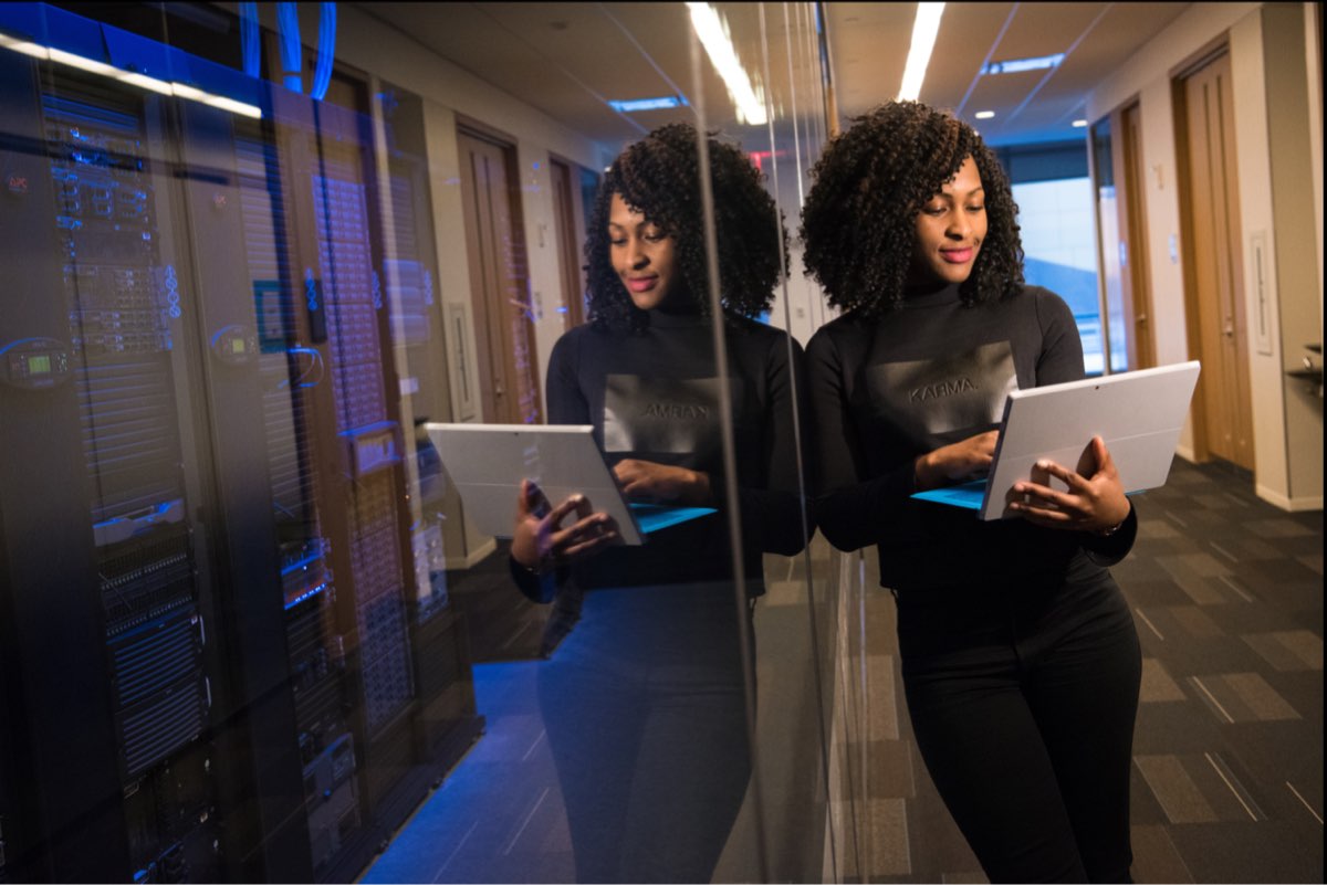 Woman in server's room operating from her laptop