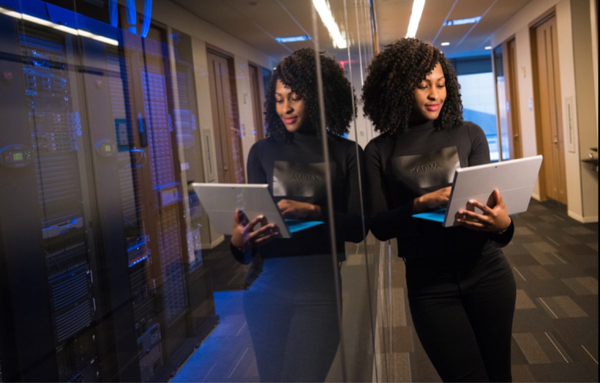 Woman in server's room operating from her laptop